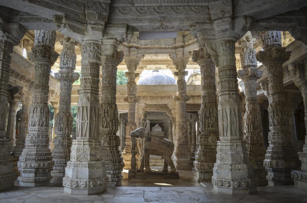 Interior view of Ranakpur Jain Temple, Ranakpur. Carvings and marble columns and a statue of an