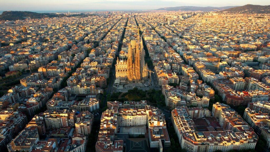 Aerial view of Barcelona city skyline and Sagrada Familia Cathedral. Eixample residential urban grid