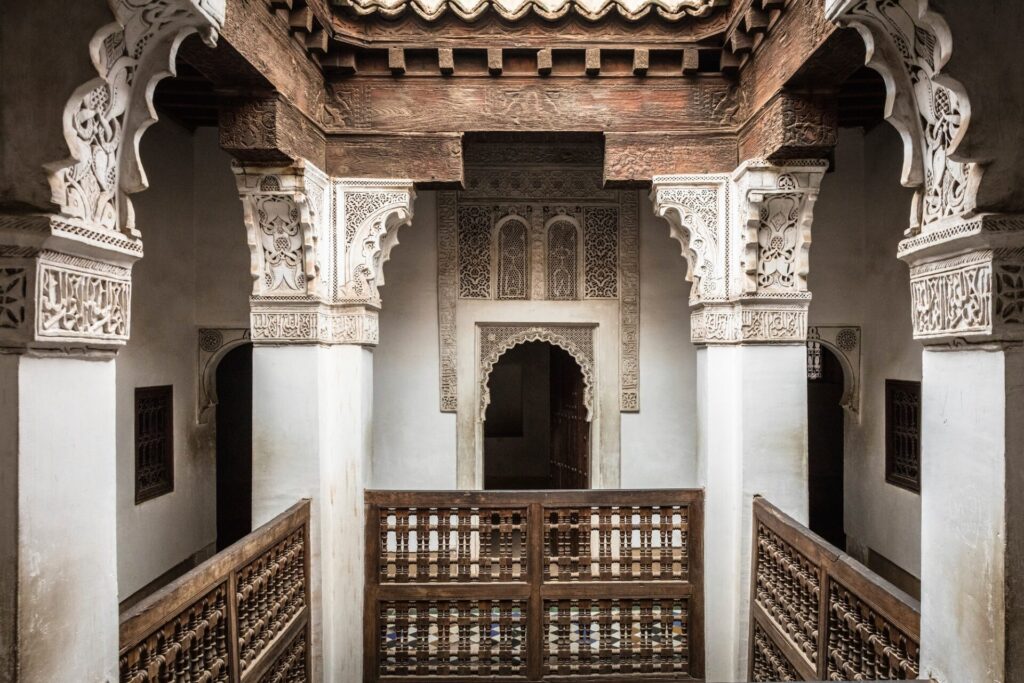Wooden balcony and marble pillars at Ben Youssef Madrasa, Marrakech, Morocco