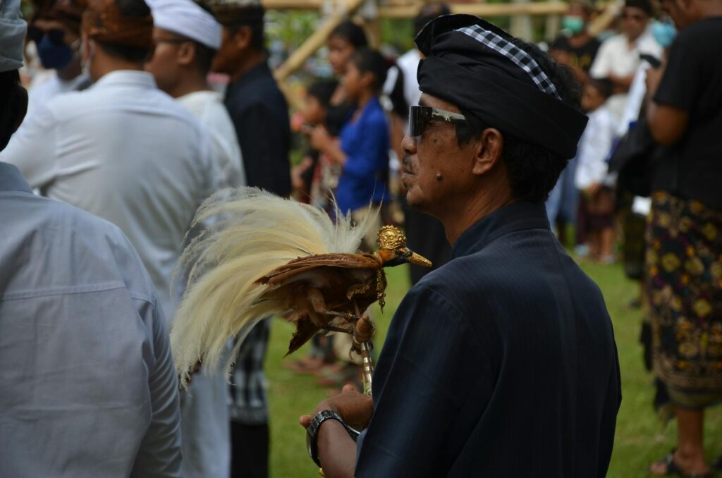 a man holding a golden bird figurine