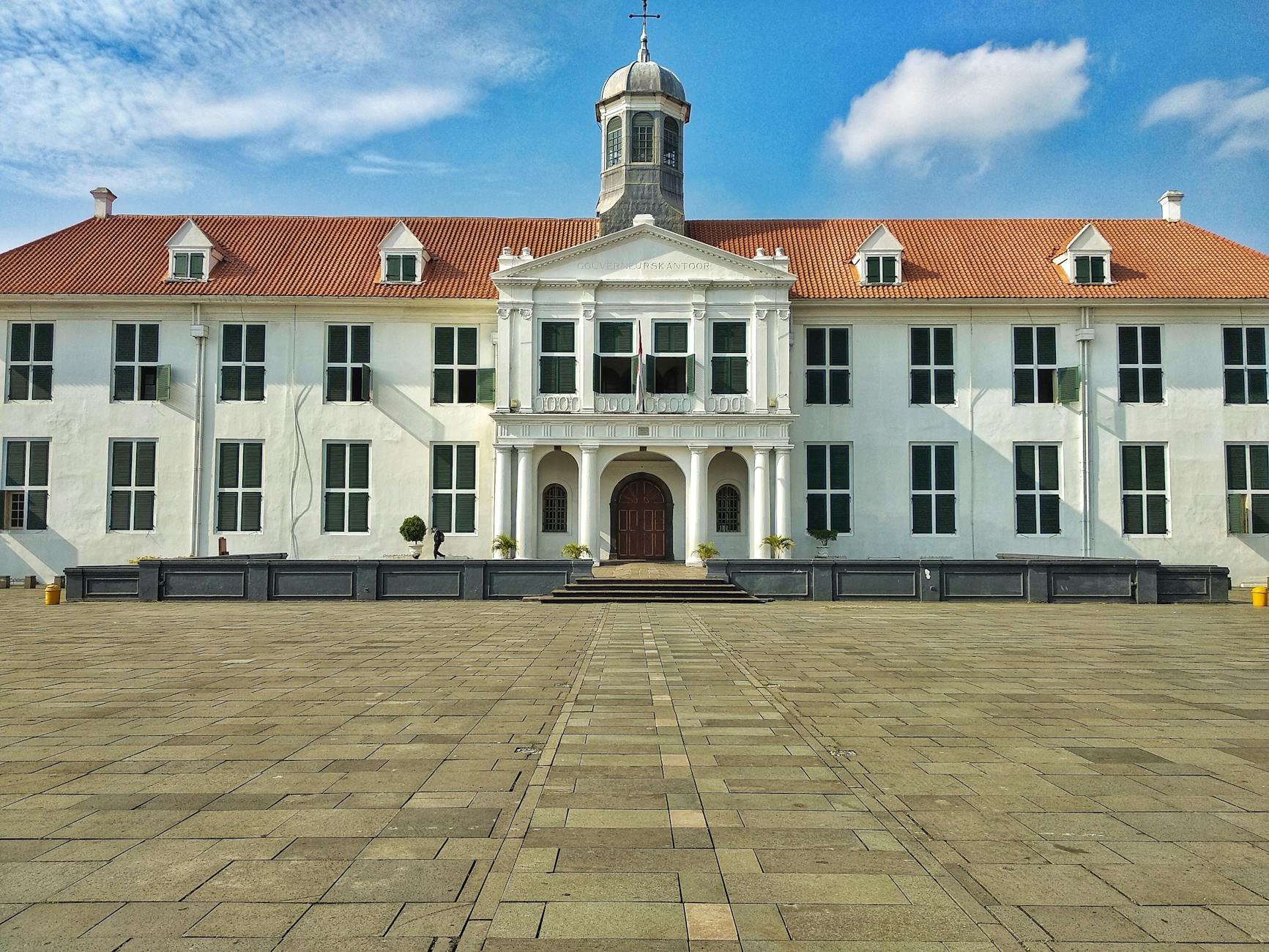 historic colonial white building with red roof