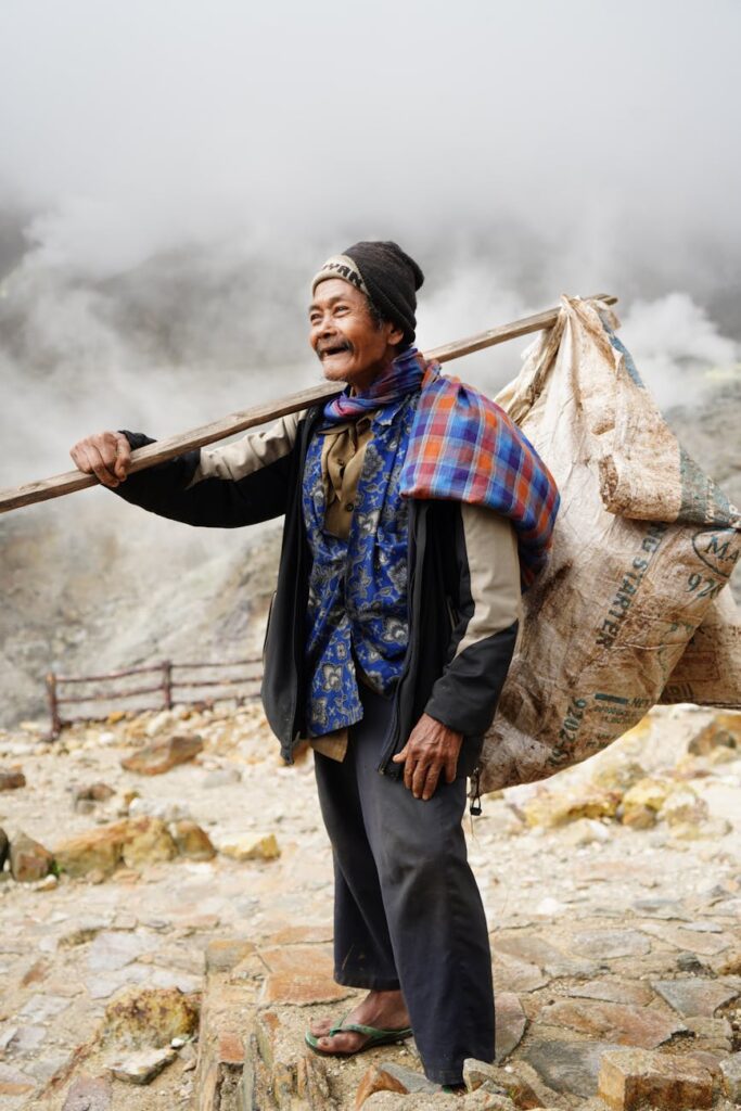 sulphur miner at kawah ijen crater indonesia