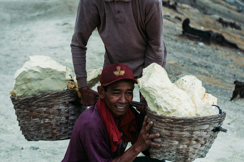 man carrying stones